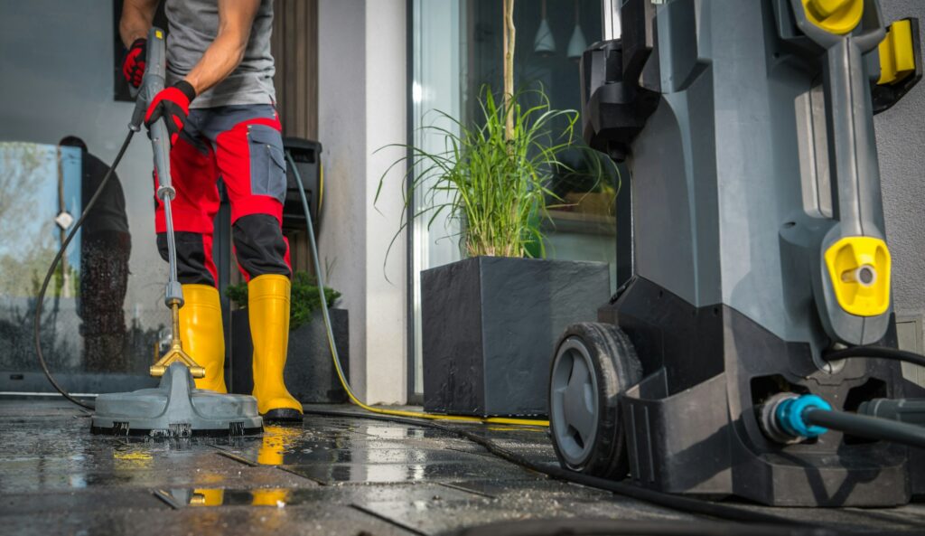 Patio Concrete Bricks Surface Cleaning Using Powerful Pressure Washer