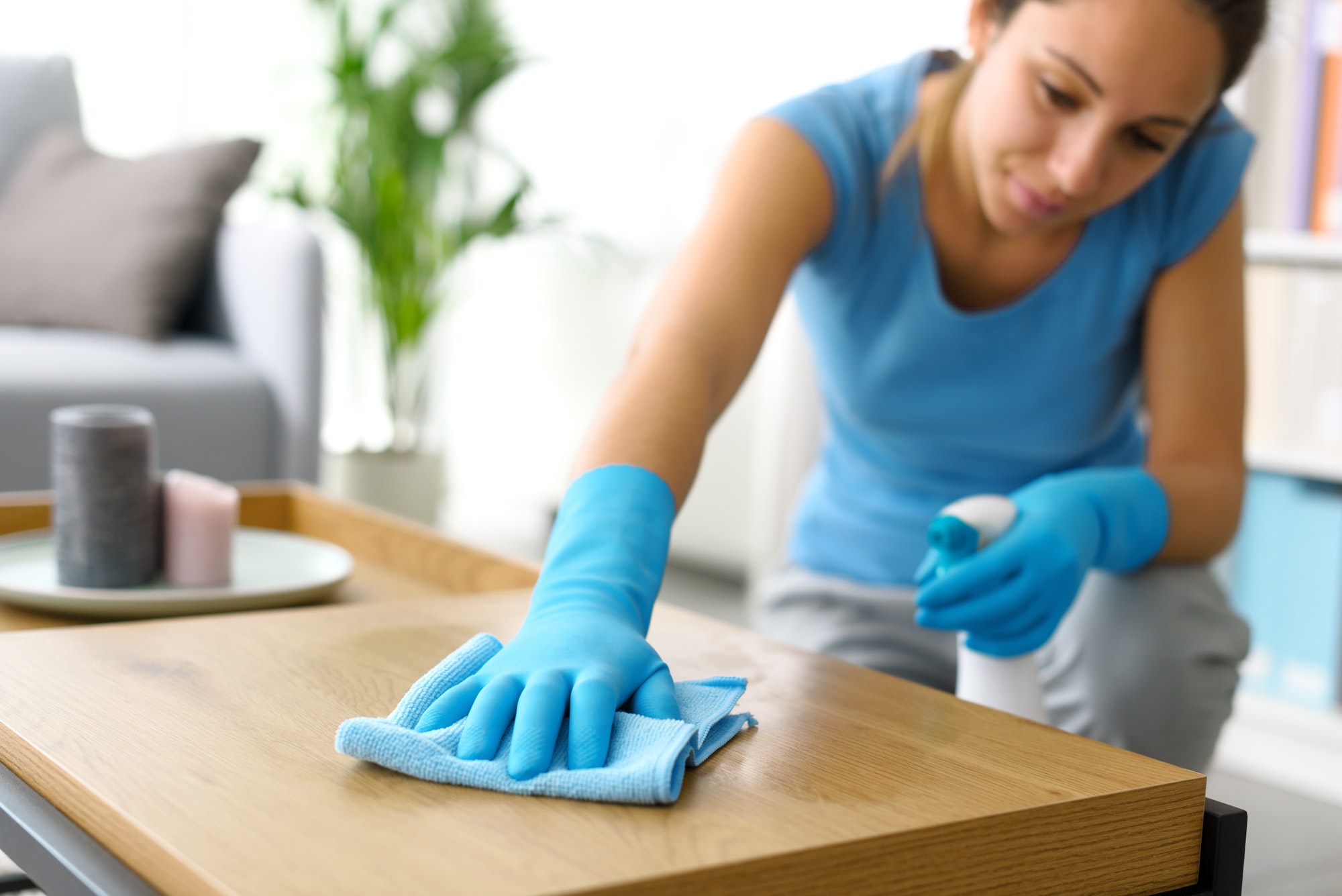 Woman cleaning a table at home